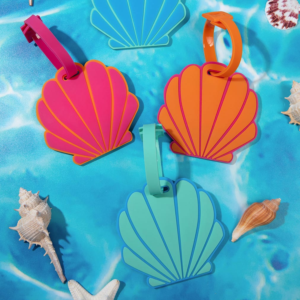 Miamica's By the Shore collection features blue, pink, orange, and aqua seashell luggage tags.